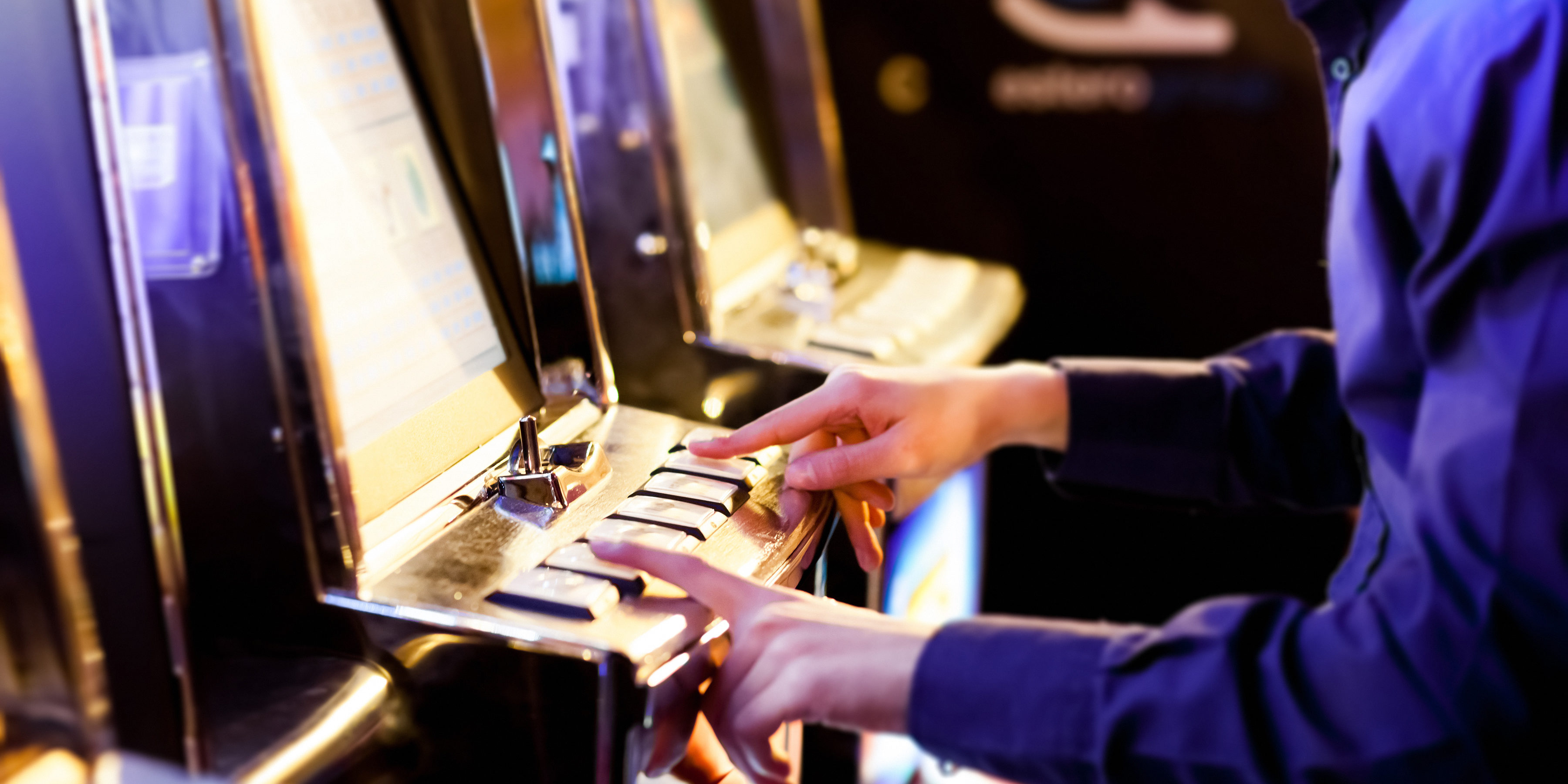 Man using an electronic slot machine