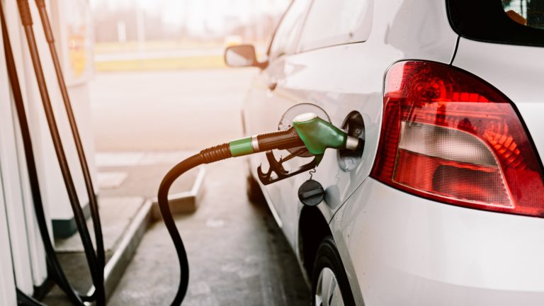 Silver car refuelling at the gas station