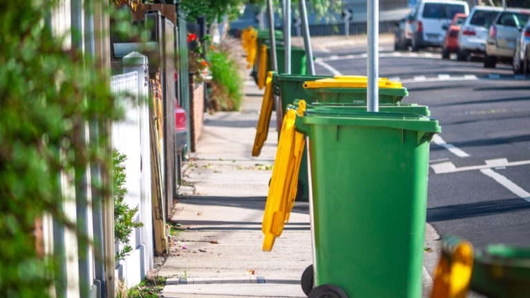 Collected kerbside waste bins on typical Australian suburban street. Footscray, VIC Australia.