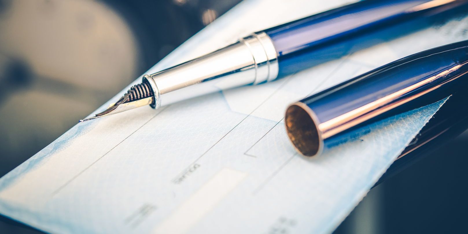 Issuing Payment by Check by Using Elegant Fountain Pen. Executive Desk Closeup.