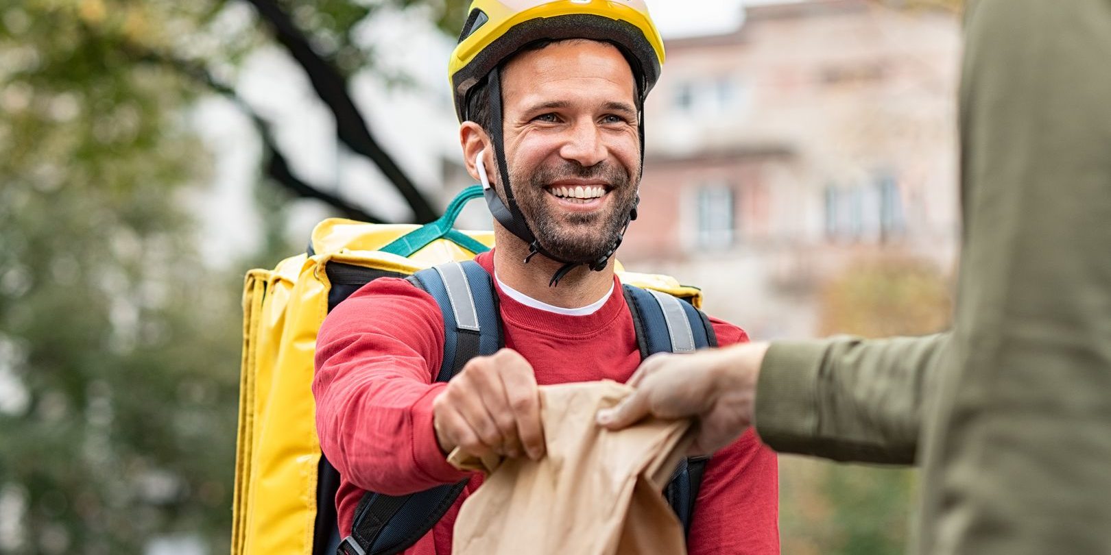 delivery-man-giving-take-away-food-DBXUQTG-hd