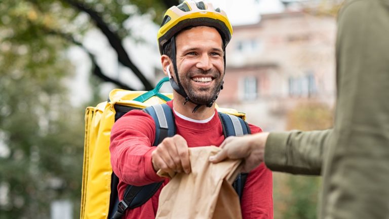 delivery-man-giving-take-away-food-DBXUQTG-hd