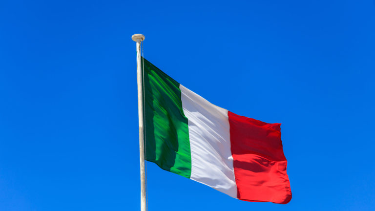 Italy flag. Italian flag on a pole waving on blue sky background