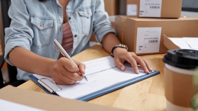 Cropped image of delivery service manager filling document